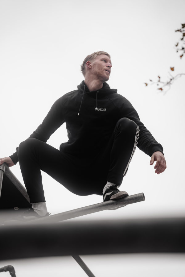 Unisex organic cotton hoody showing the front with Justice in Motion logo