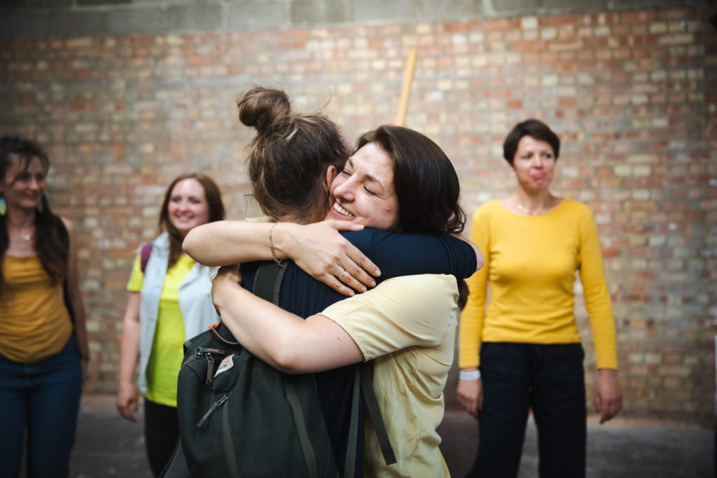 Maryna and Anja hug after the dance performance of RESISdANCE at OVADA Gallery in 2023